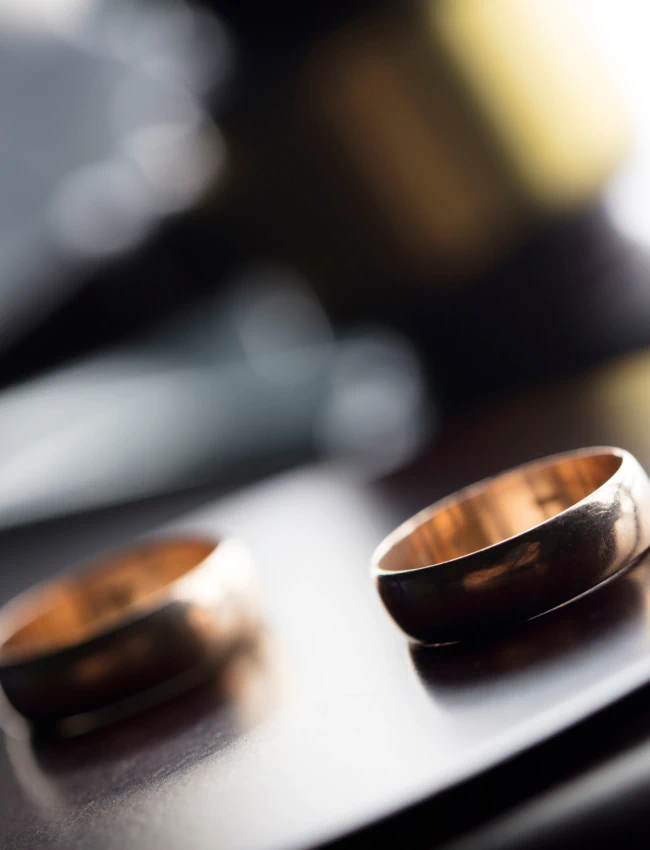 wedding rings and a gavel in the background
